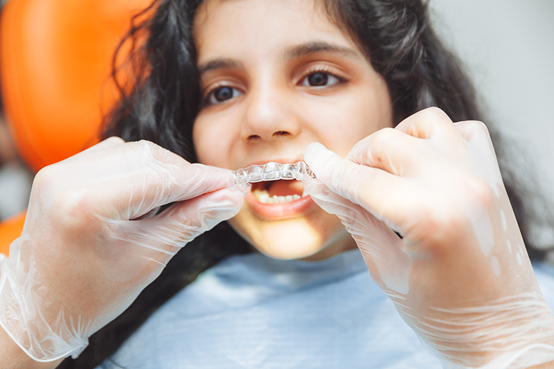 Child getting retainers after orthodontic treatment